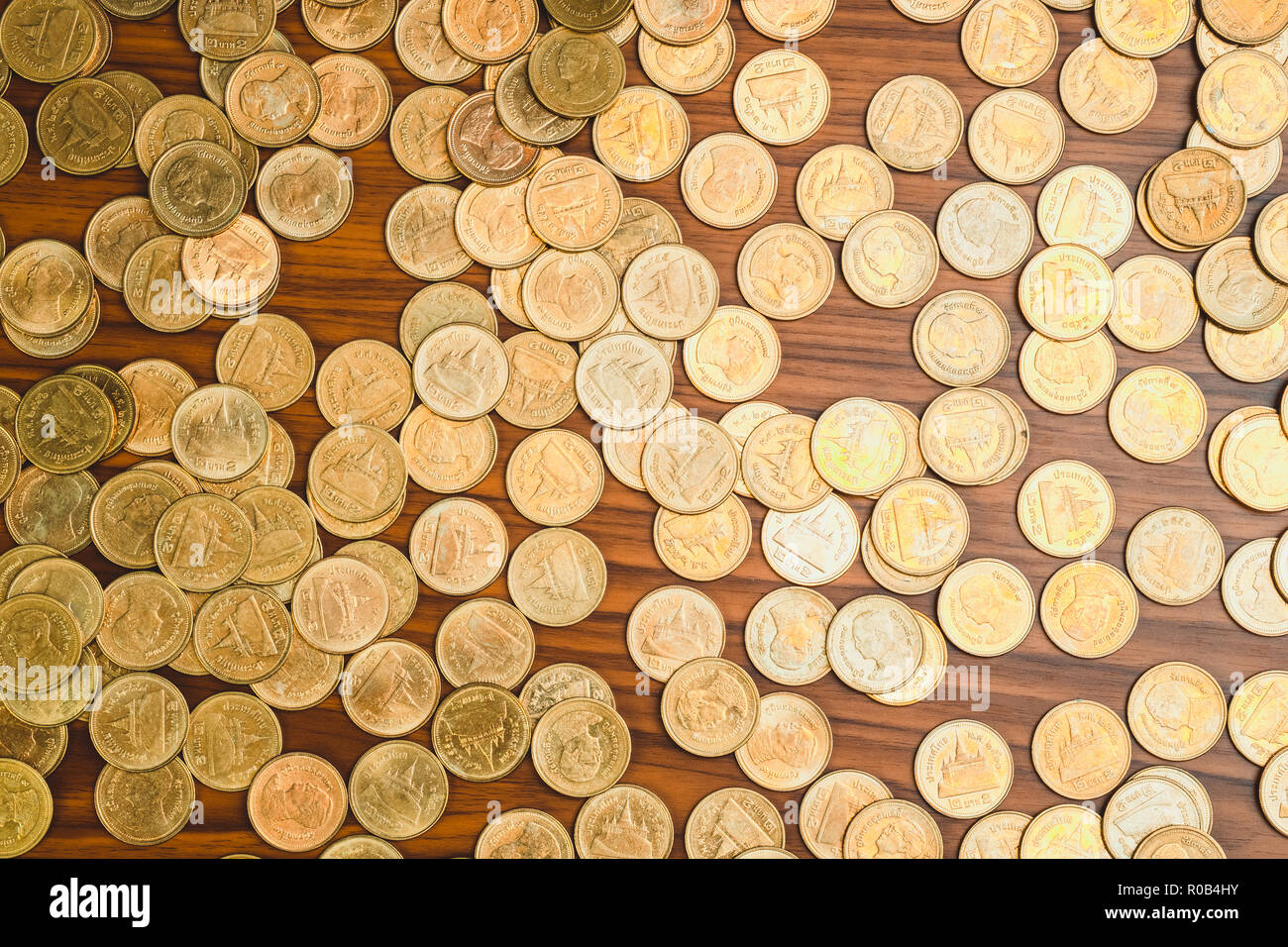 Stack of coin on wooden working table, business and finance concept ...