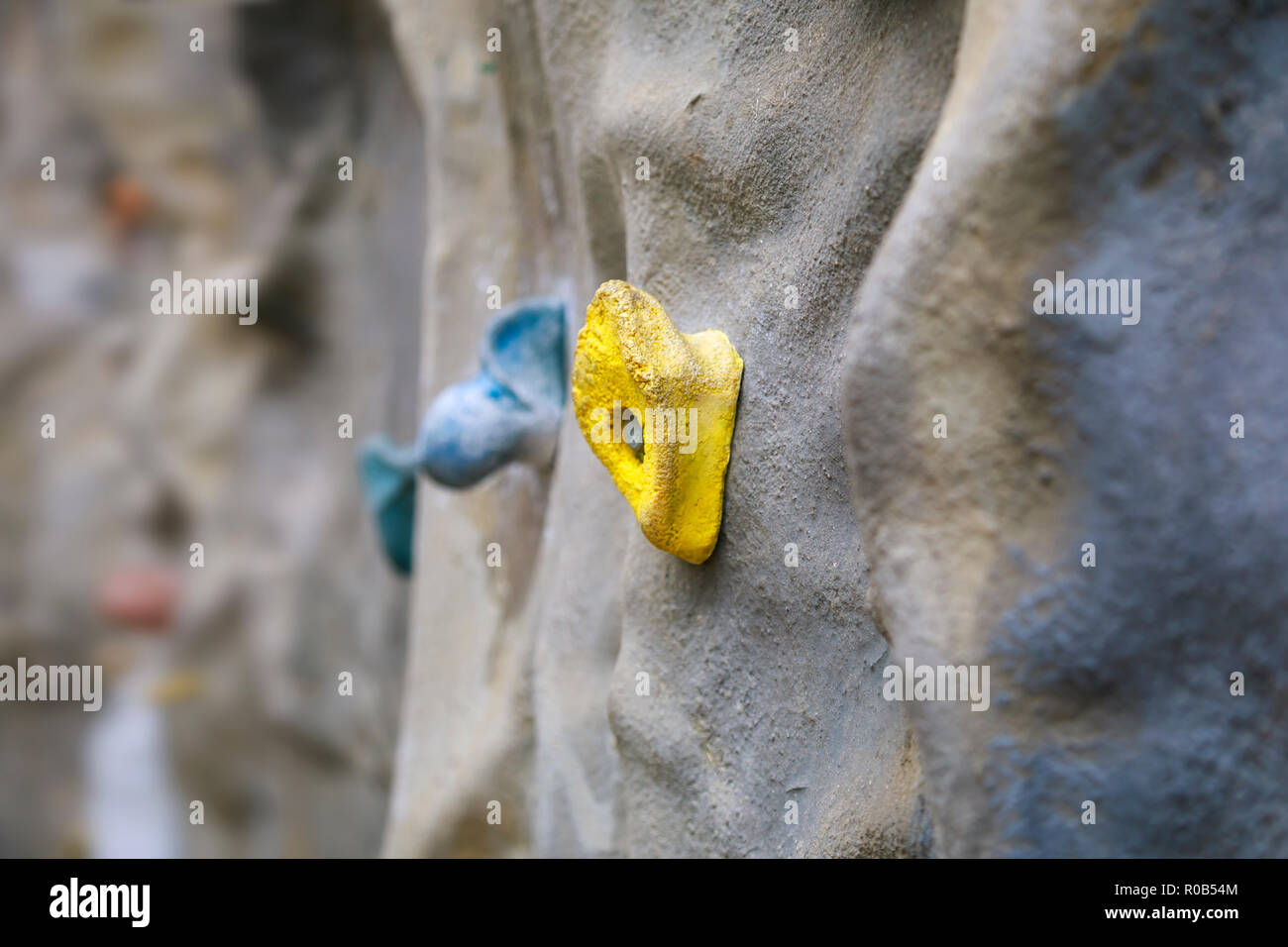 Artificial climbing wall with yellow grip Stock Photo