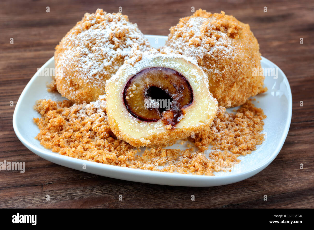 Plum dumplings on wooden table Stock Photo
