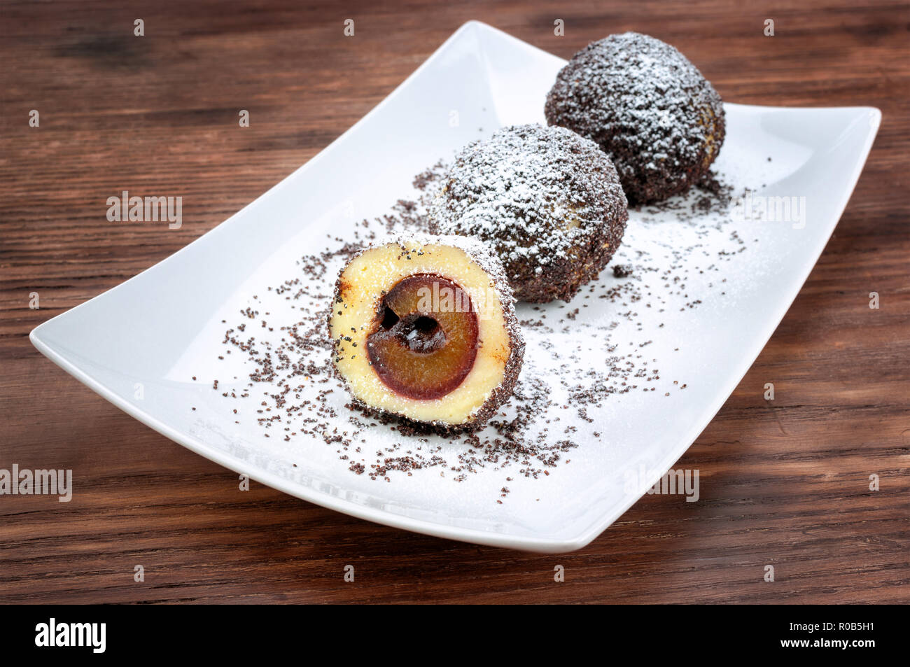 Plum dumplings on wooden table Stock Photo