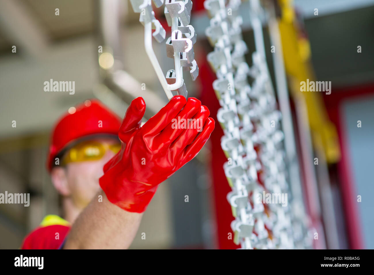 Factory engineer checking production line with red protective gloves Stock Photo