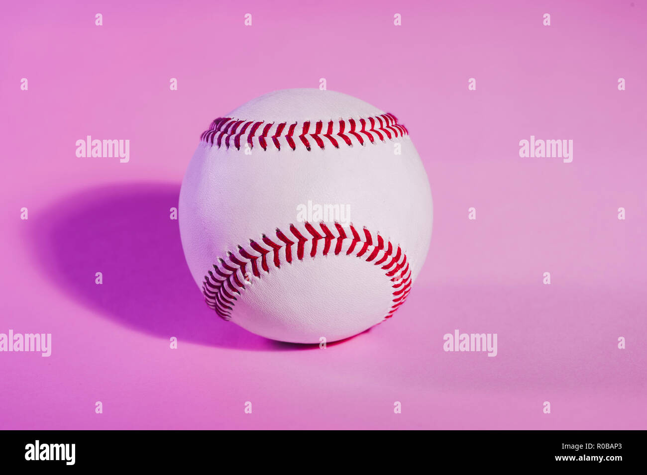 baseball on a Pink color background and red stitching baseball. copy space. Stock Photo