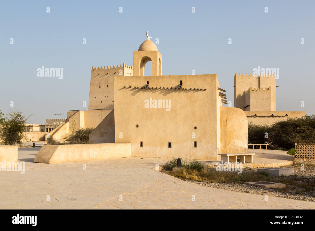 Barzan watchtowers and an Old mosque built with coral rock and limestone, Umm Salal Mohammed Fort Towers, ancient Arabian fortification near Umm Salal Stock Photo