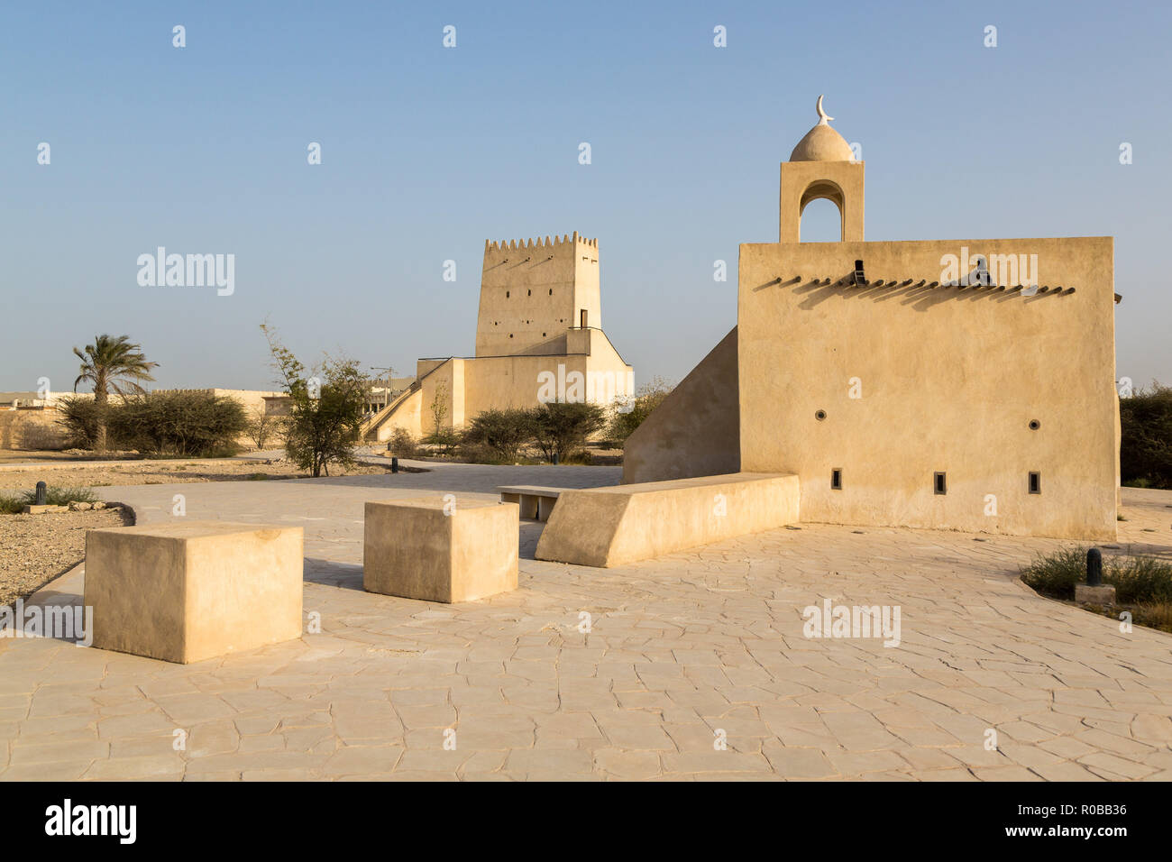 Barzan watchtowers and an Old mosque built with coral rock and limestone, Umm Salal Mohammed Fort Towers, ancient Arabian fortification near Umm Salal Stock Photo