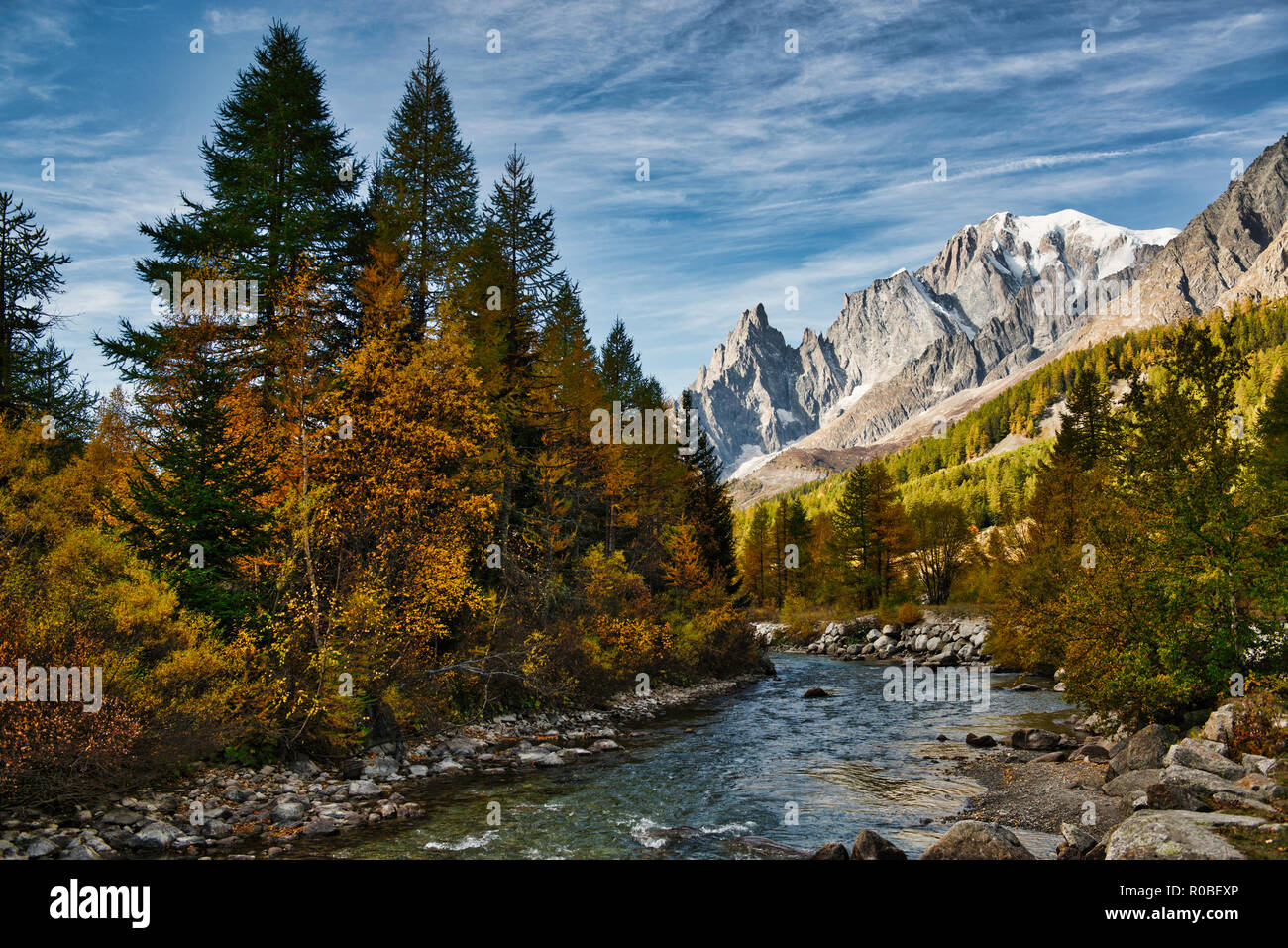 The river in Ferret Valley during the autumn season with the Mont Blanc wall in the background and clouds in the sky Stock Photo