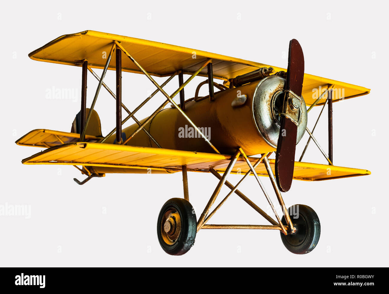 Yellow toy plane on an isolated background Stock Photo