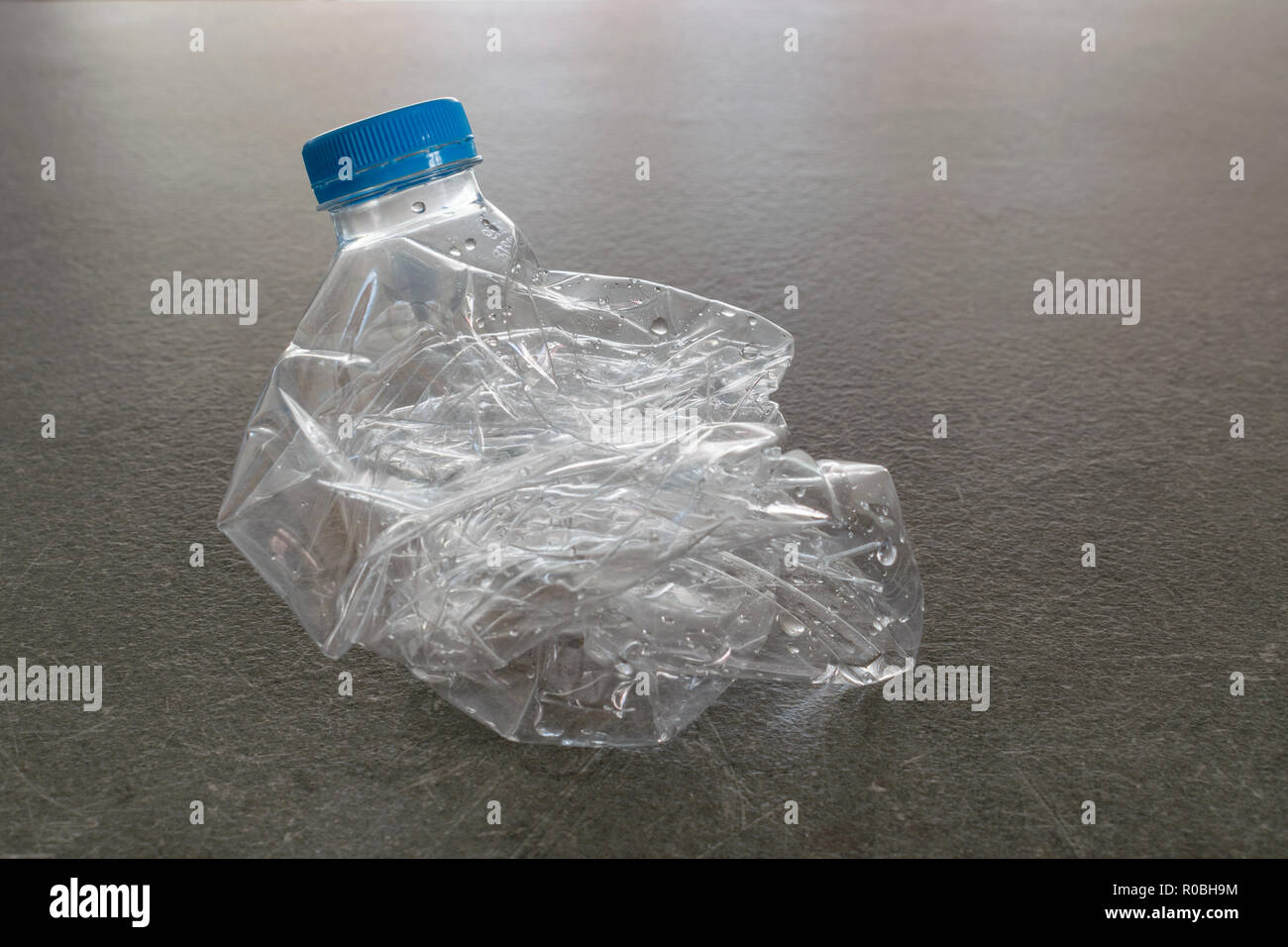 Plastic water bottle crushed and pressed for recycling, recycle concept, less volume Stock Photo