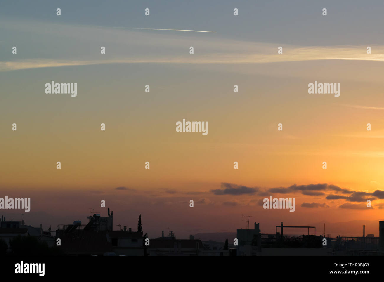 Sunset with cityscape in dark shadow, blue orange soft colors Stock Photo