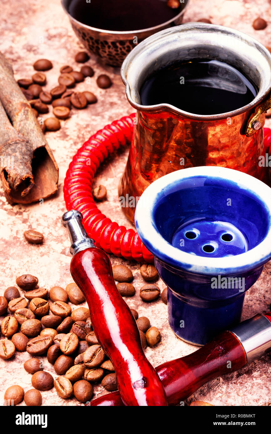 Stylish coffee jezva with coffee and hookah mouthpiece.Arabian shisha ...