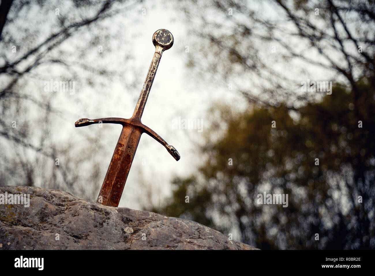 Excalibur the famous sword in the stone of king Arthur in the forest