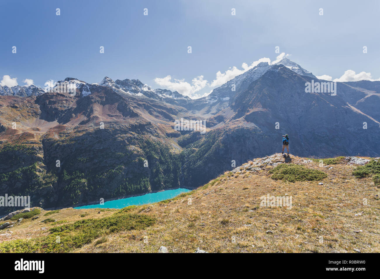 A man take a picture of Lake Place Moulin glacial reservoir, Aosta Valley, Italian Alps, Italy, Europe Stock Photo