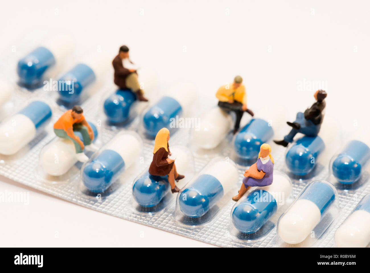 People sitting on capsules Stock Photo
