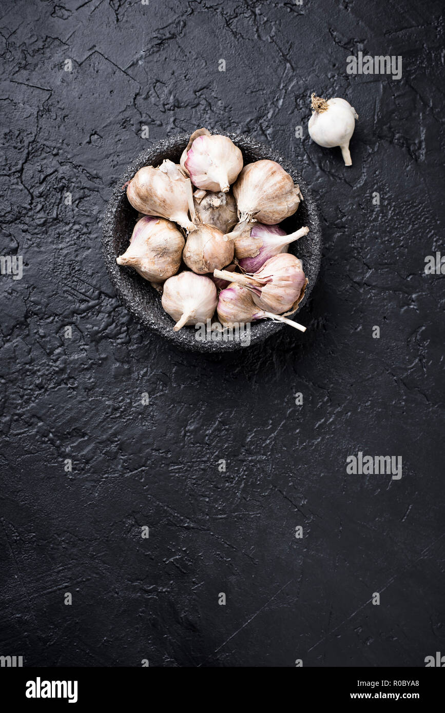 Fresh garlic on black background Stock Photo - Alamy