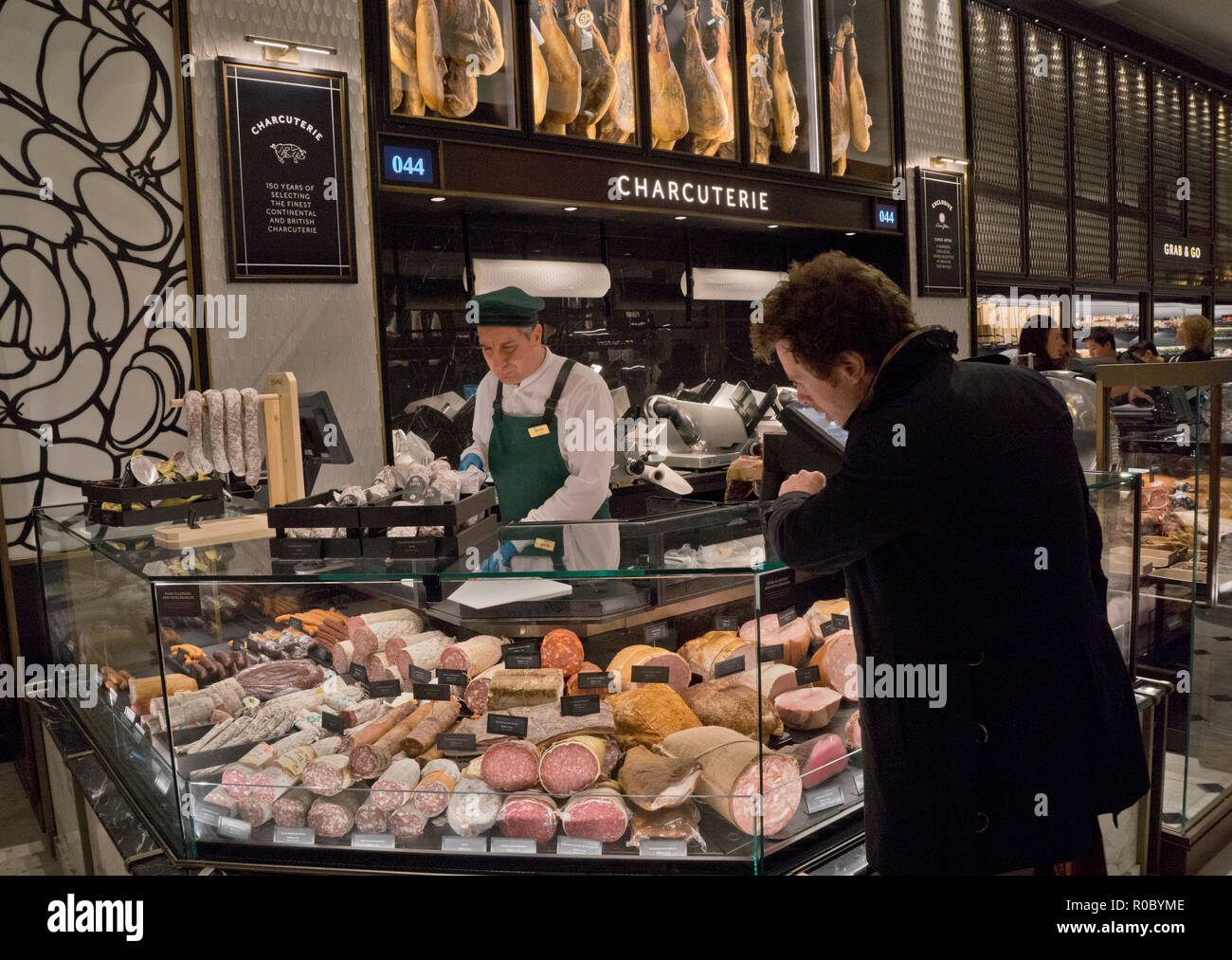 Customer at the charcuterie food counter at Harrods luxury department