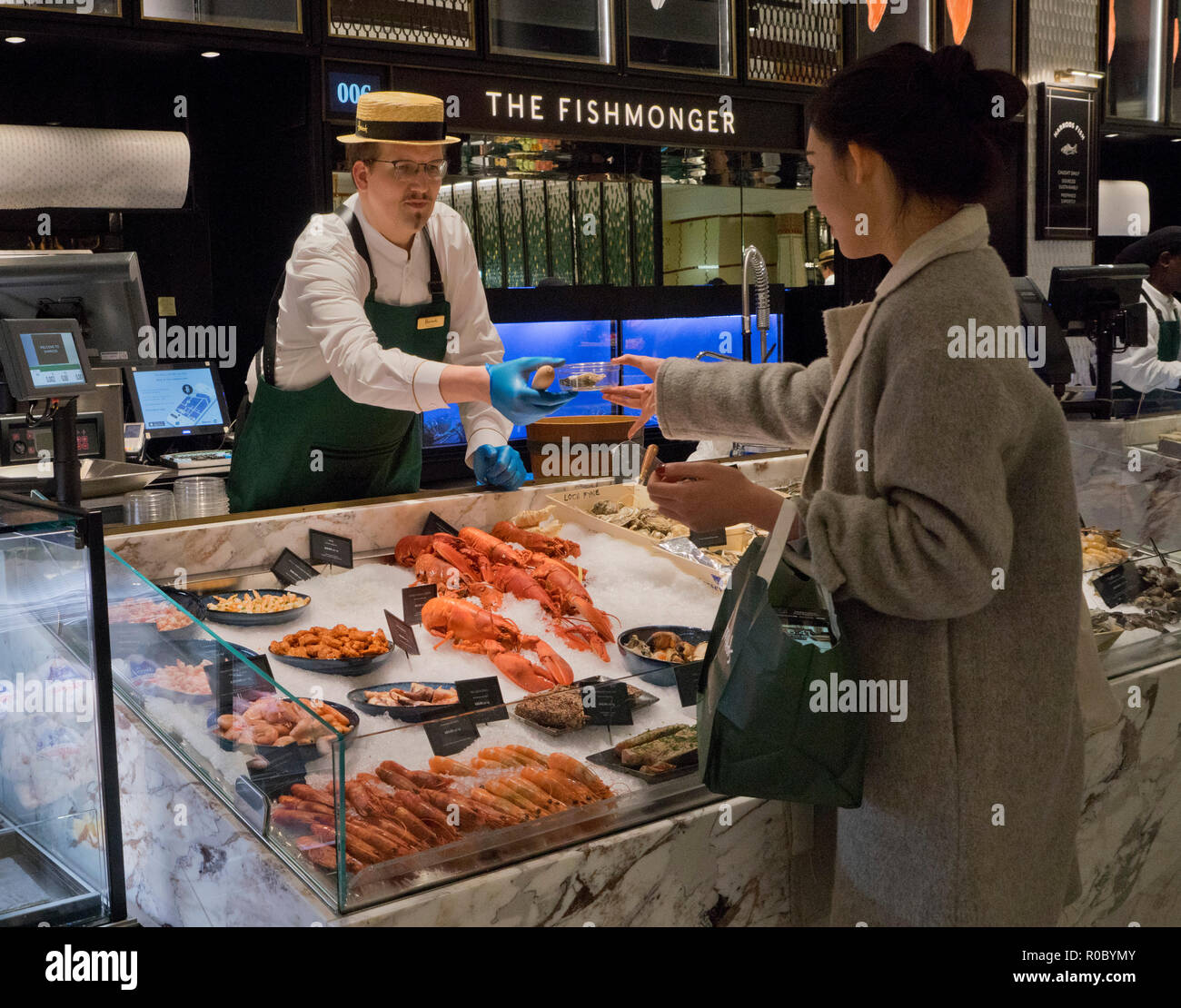 Customer at the fishmonger food counter at Harrods luxury department