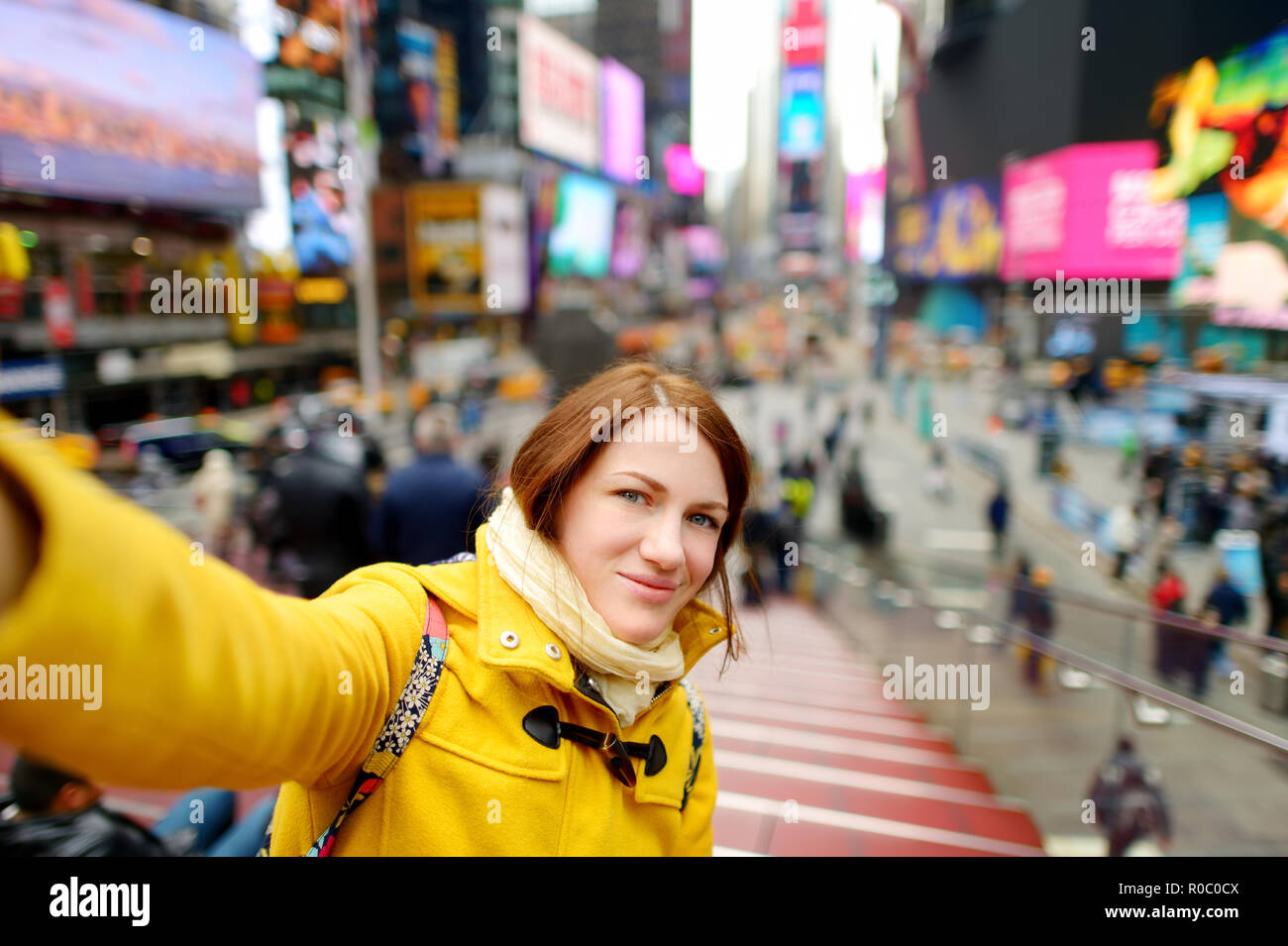 Happy young woman tourist sightseeing at Times Square in New York City ...