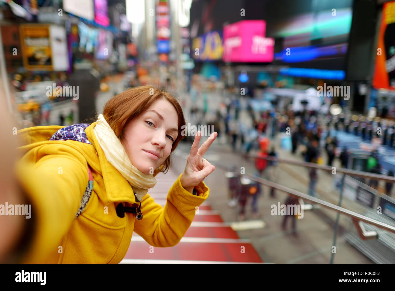 Happy young woman tourist sightseeing at Times Square in New York City ...