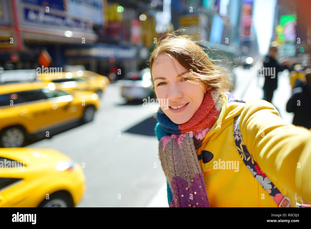 Happy young woman tourist sightseeing at Times Square in New York City ...