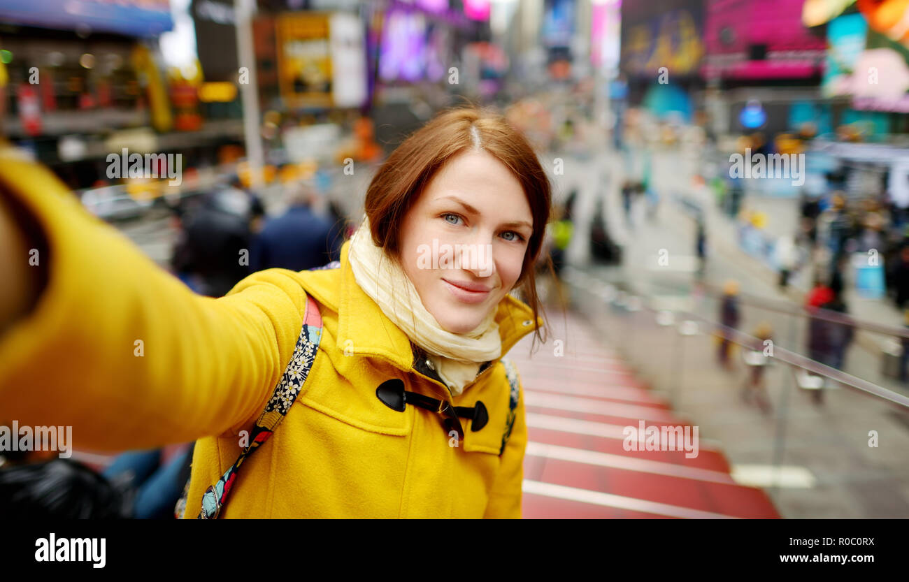 Happy young woman tourist sightseeing at Times Square in New York City ...