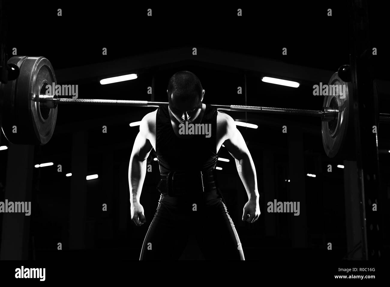 Powerlifter Working Out Legs With Barbell In A Gym Squat Exercise