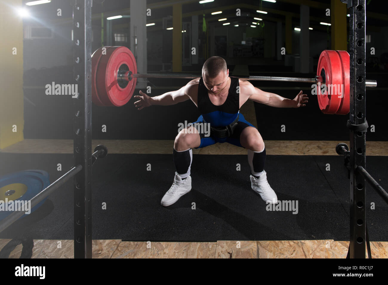 Powerlifter Working Out Legs With Barbell In A Gym Squat Exercise