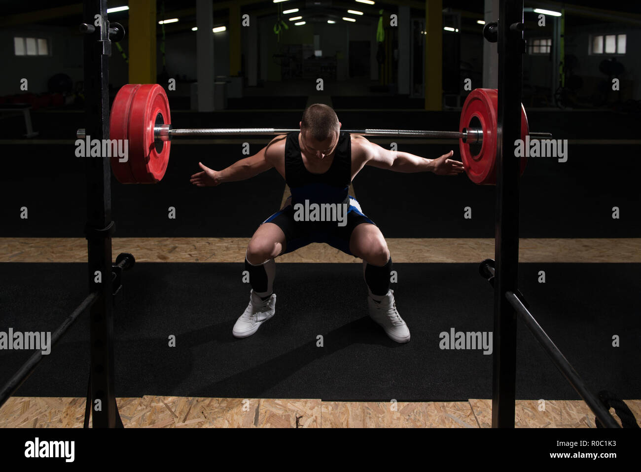 Healthy Powerlifter Man Working Out Legs With Barbell In A Gym Squat Exercise Stock Photo Alamy