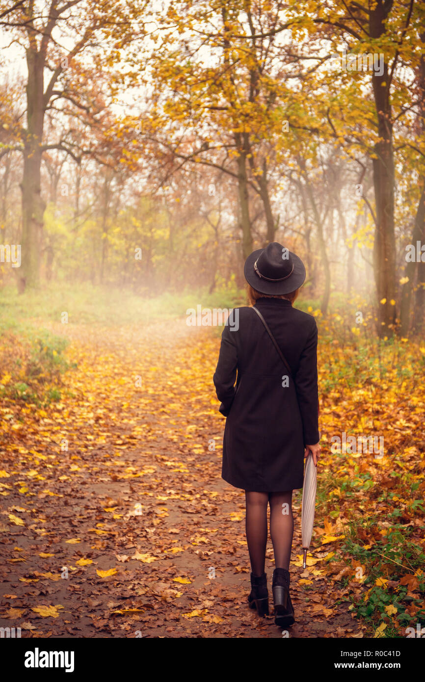 woman walking with umbrella Stock Photo - Alamy