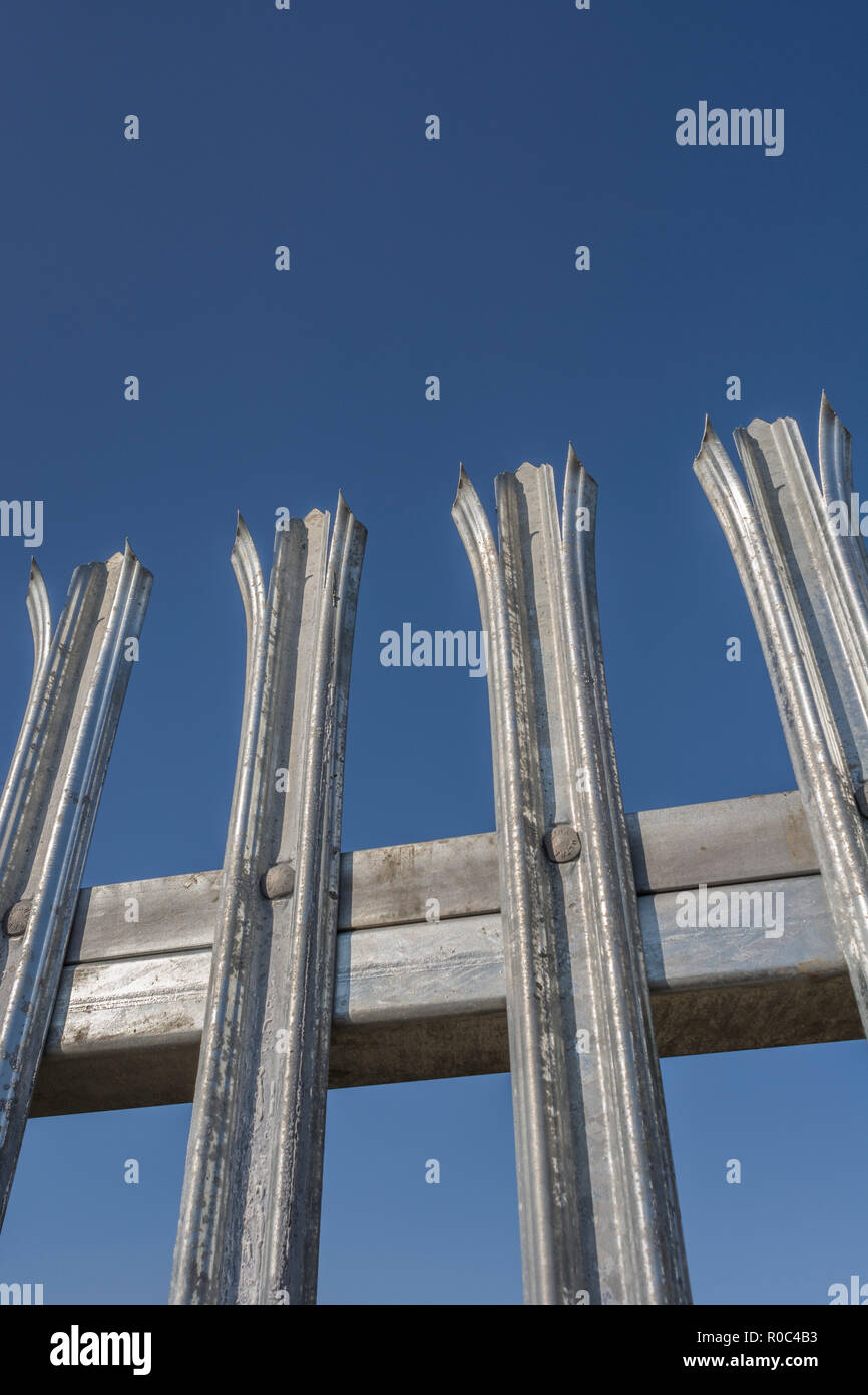 Robust galvanised anticlimb steel fence metaphor 'Keep Out', concept of barriers and US