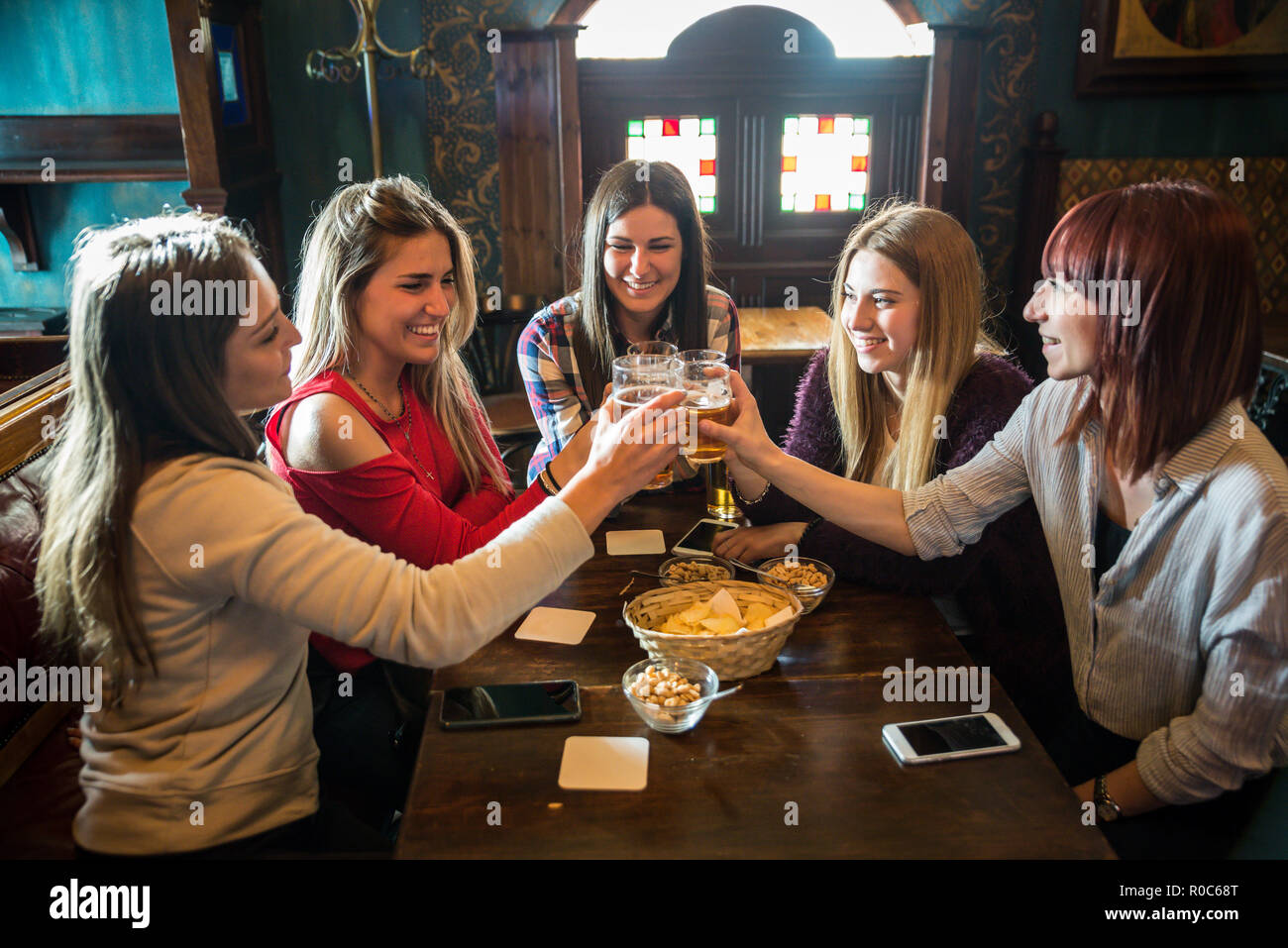 Group of happy friends having party in a bar - Young people drinking ...