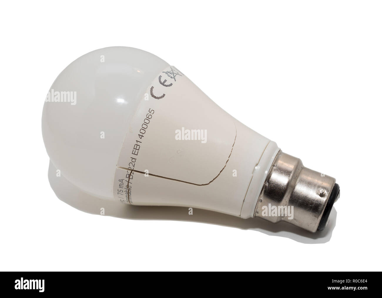 LED light bulb with crack in housing, isolated on a white background. Stock Photo