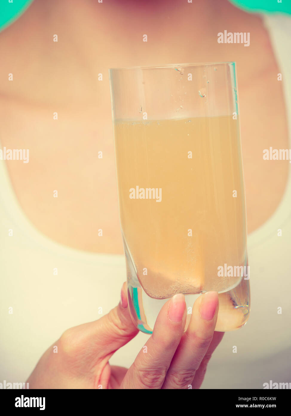 Vitamins, health, medicines. Woman holding glass with orange flavored