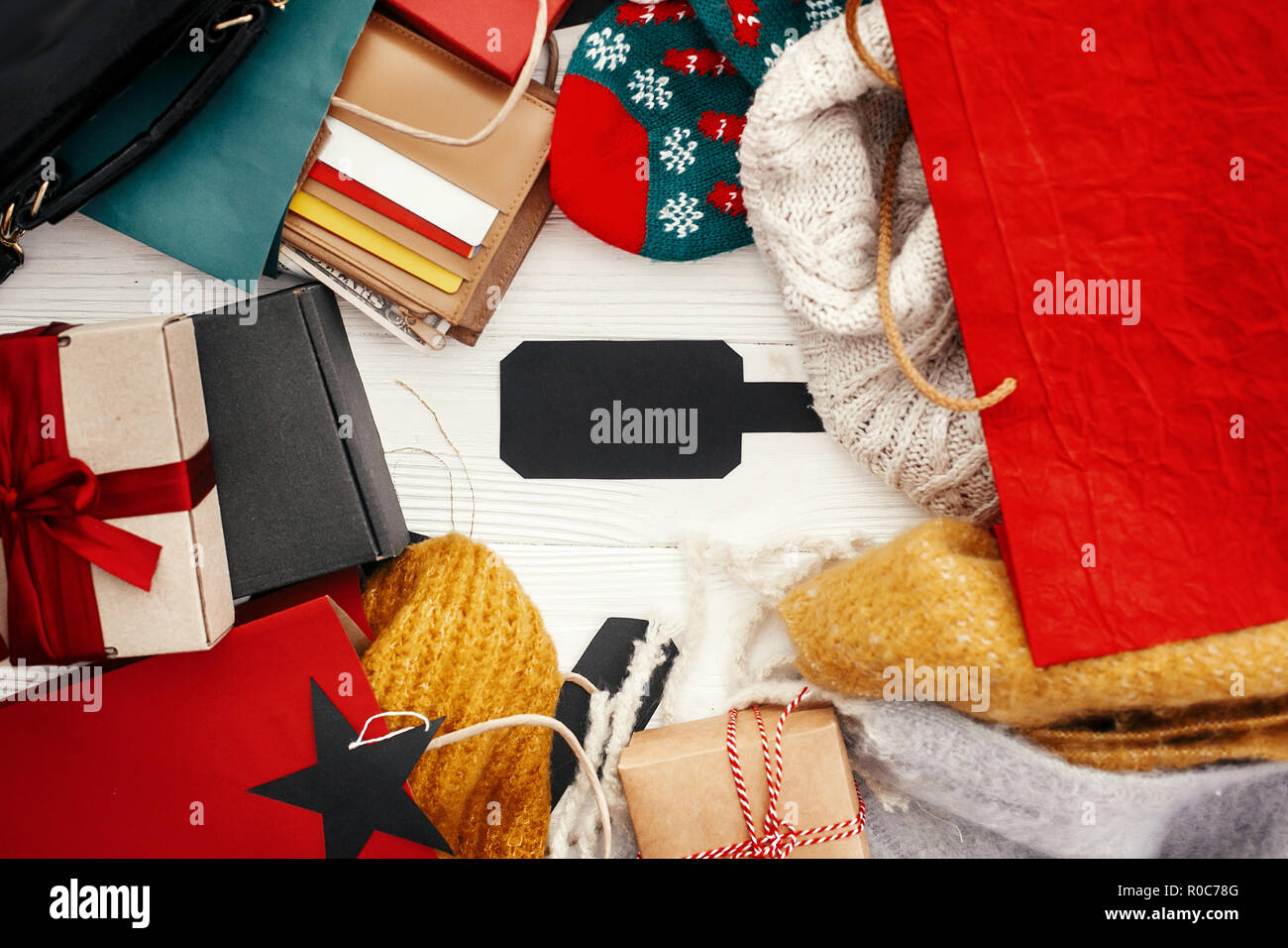 Christmas shopping and seasonal sale. Credit cards, money, wallet, bags,  clothes, gift boxes on rustic wood. Empty black tag with Space for text.  Adv Stock Photo - Alamy