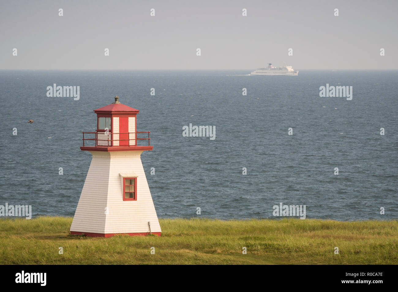 CTMA ferry Madeleine in the background of lighthouse at Cap Alright ...