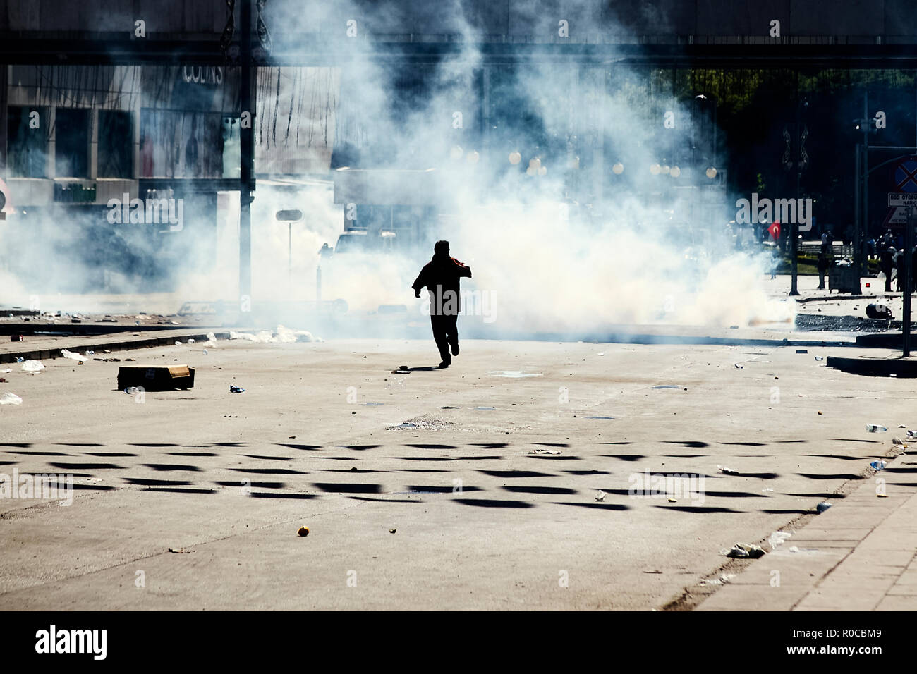 A protester trying to run away from the tear gas fired by the police during the Gezi park protests in Ankara, Turkey Stock Photo