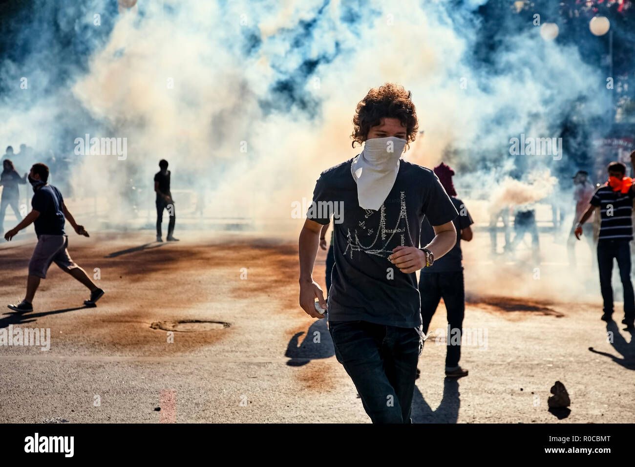 Male protester running away from the tear gas smoke fired by the police during Gezi park protests in Ankara, Turkey. Stock Photo