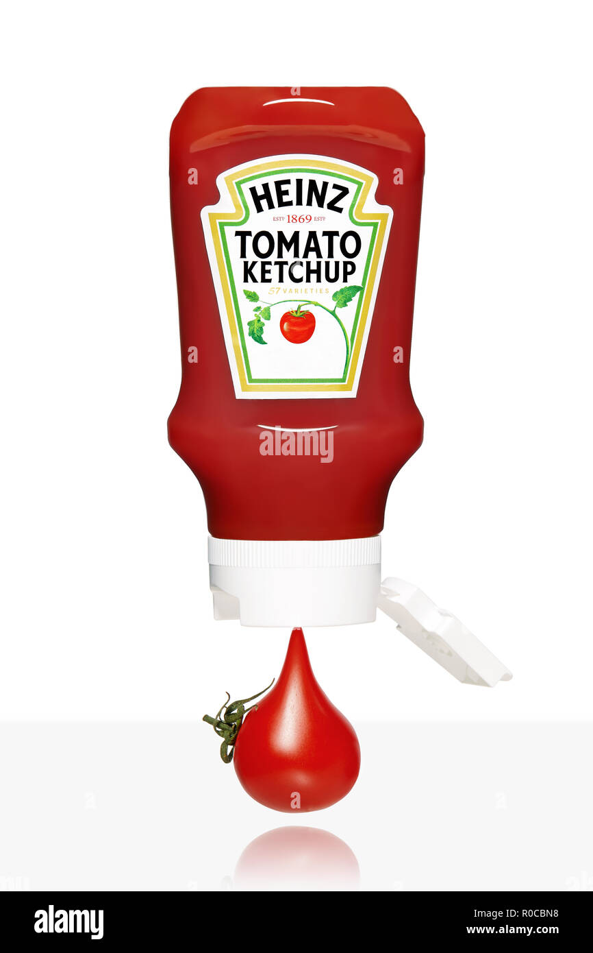 Cherry tomato dripping from the plastic bottle of Heinz ketchup on