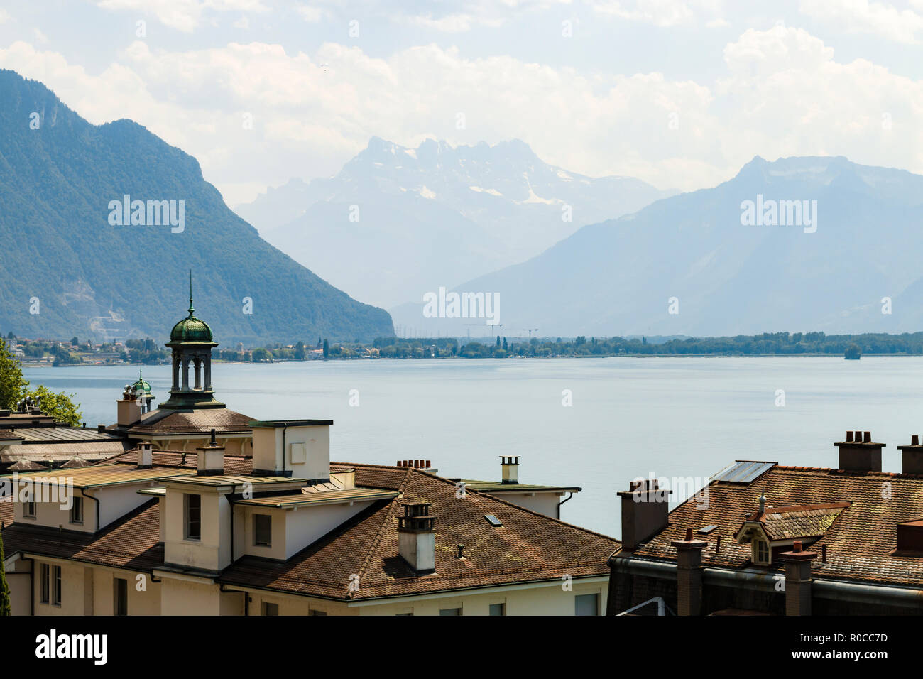 View over roofs at Geneva lake and the Alps in the background Stock Photo