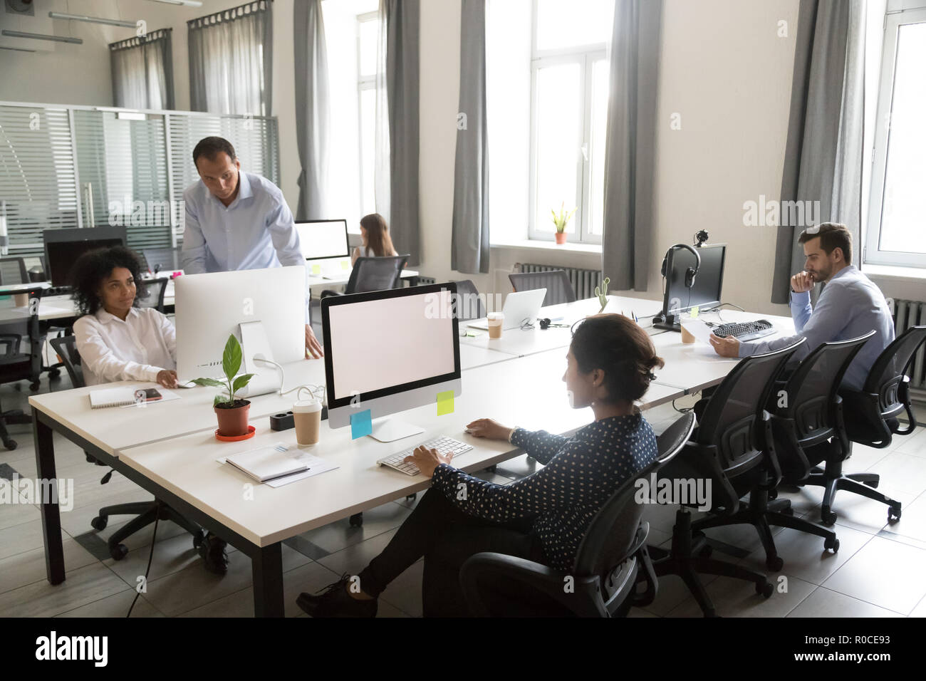 Diverse multi-ethnic people employees working together in shared Stock Photo