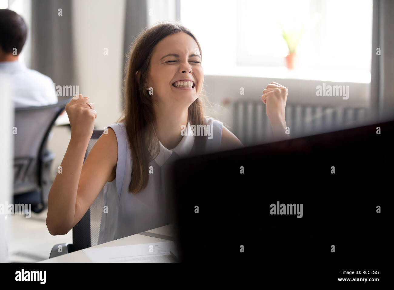 Happy euphoric millennial girl winner excited by good news Stock Photo