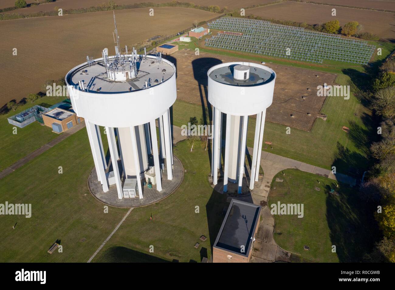 Two large iconic Water Towers situated to the North West of Corby, Northamptonshire, with a Solar Farm under construction in the background. Stock Photo