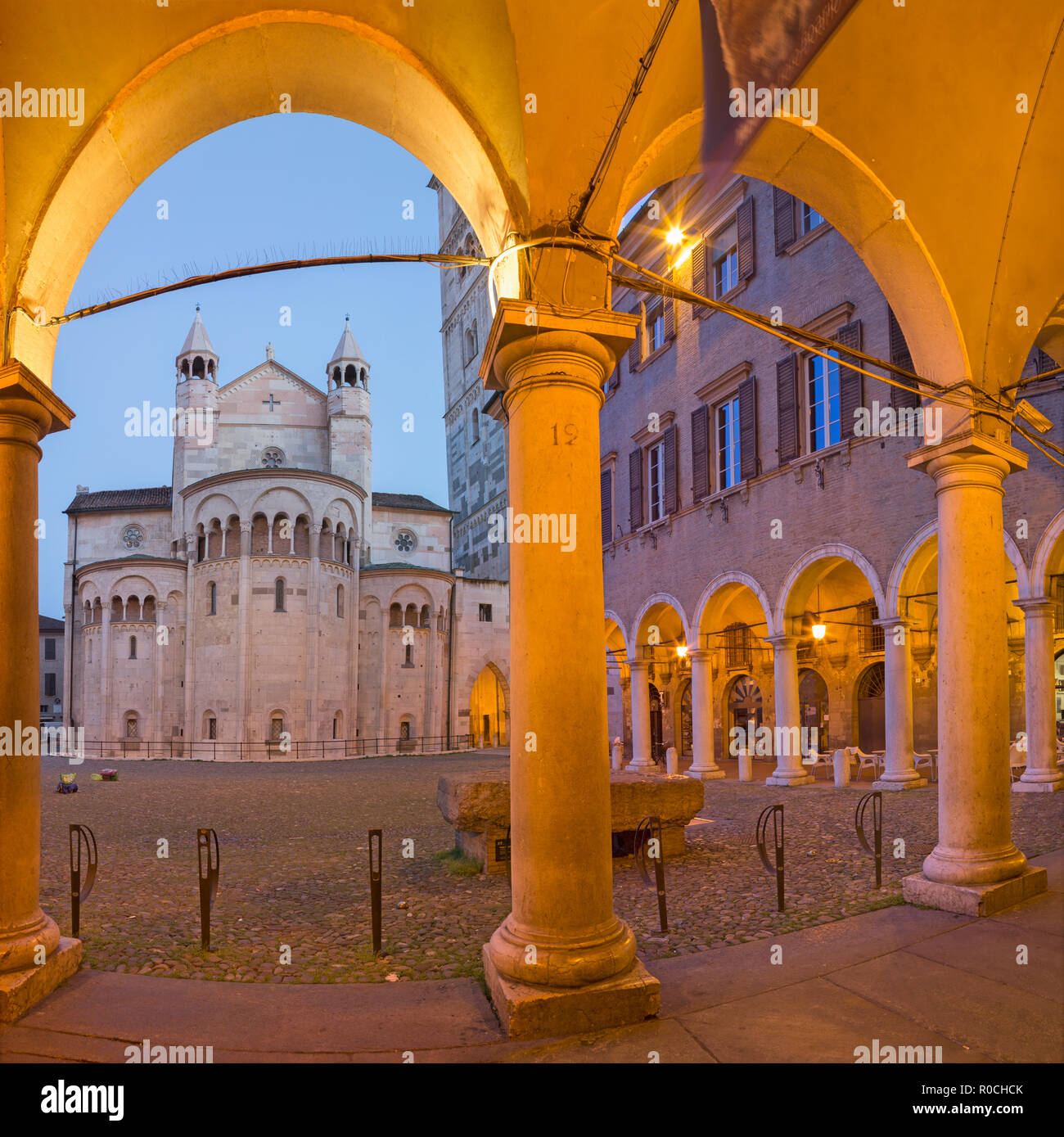 Modena - The porticoes on the Piazza Grande square at dusk with the Dome. Stock Photo