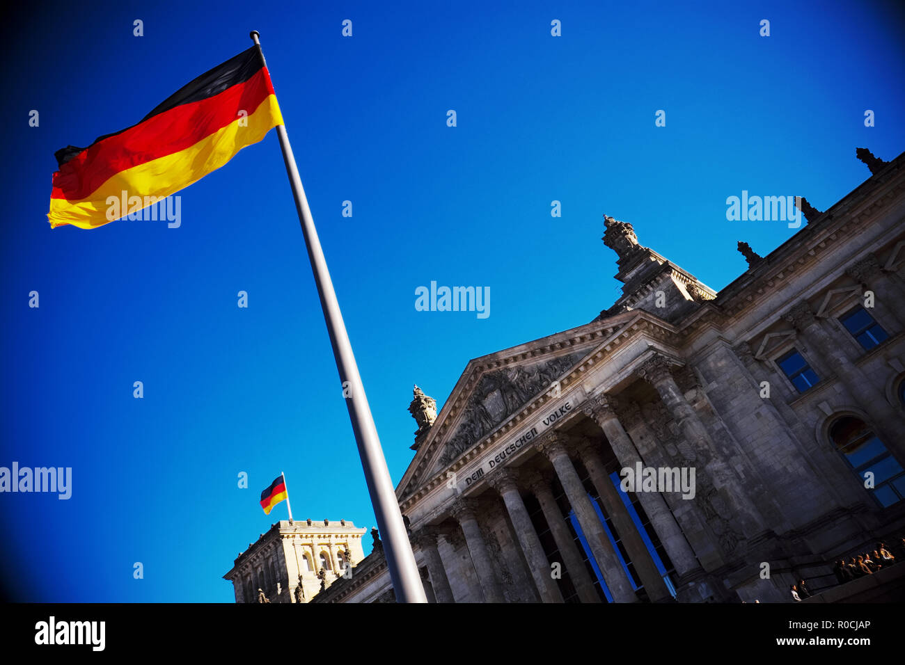 Berlin, Germany - German national flag outside the Reichstag building  home to the German parliament Stock Photo