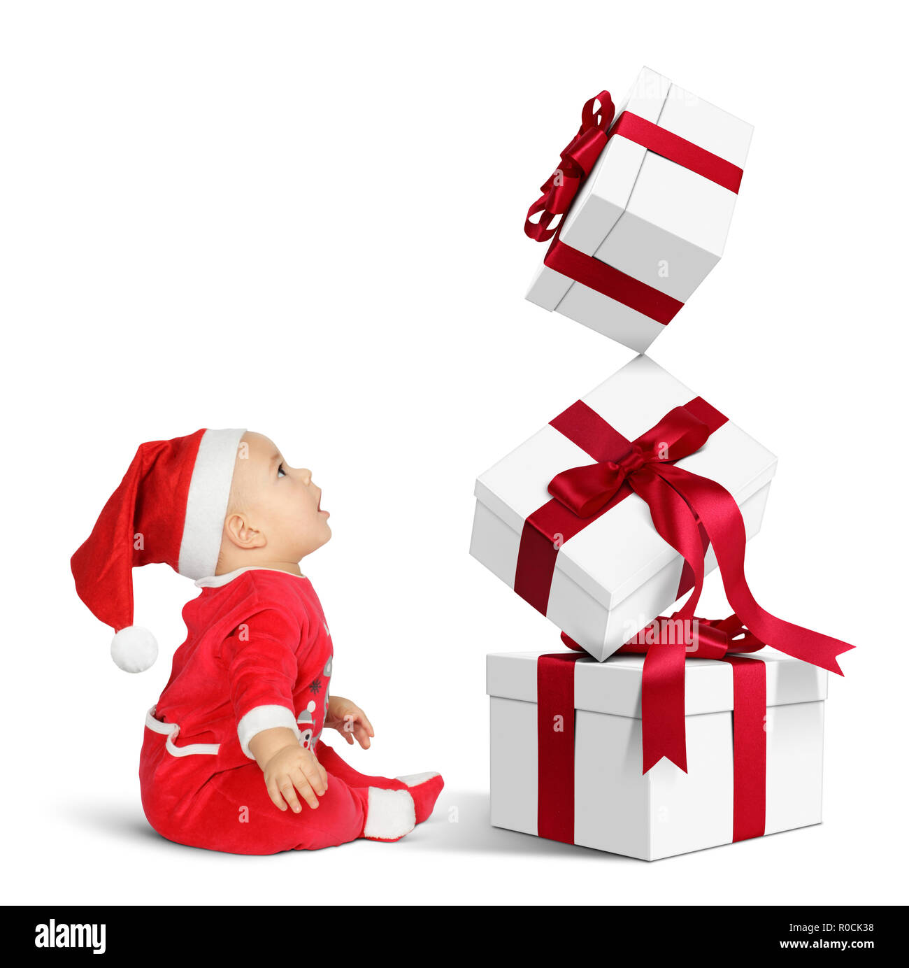 surprised Little baby Santa Claus with Christmas gifts, side view Stock ...