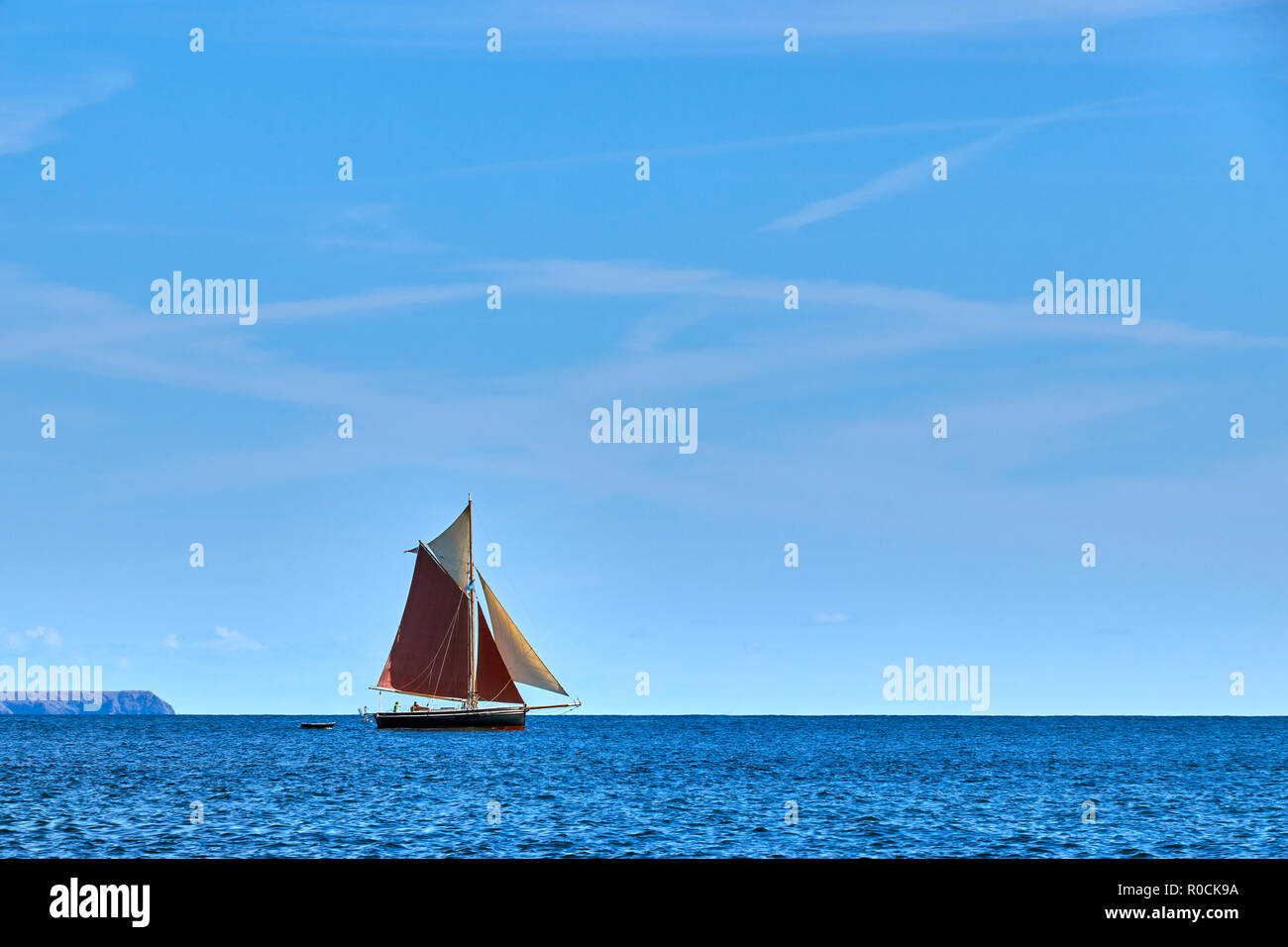 Gaff rigged traditional sailing boat sailing along the English Channel off Cornwall Stock Photo