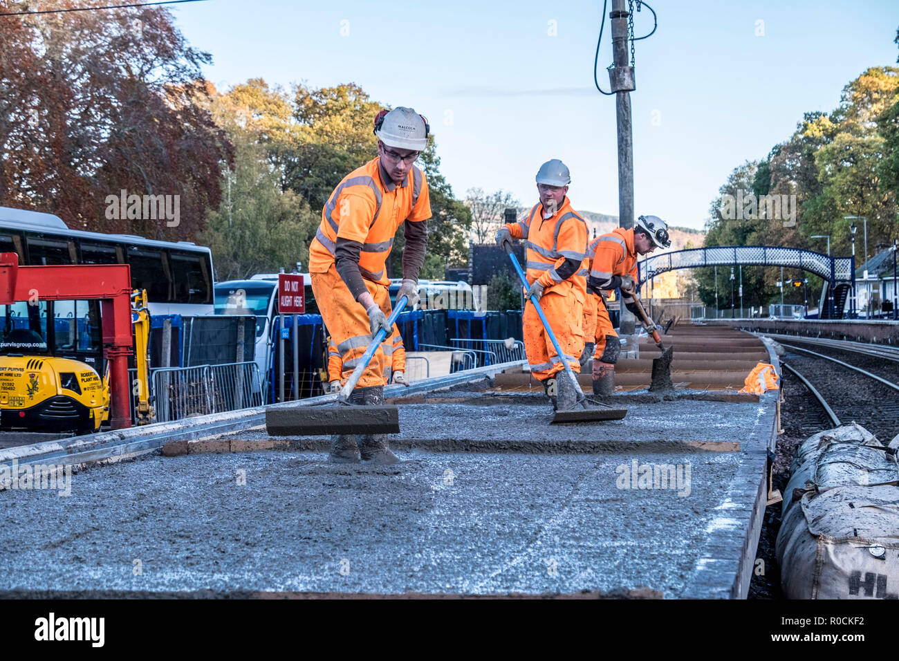 Rail Construction workers building a new platform in station Stock Photo