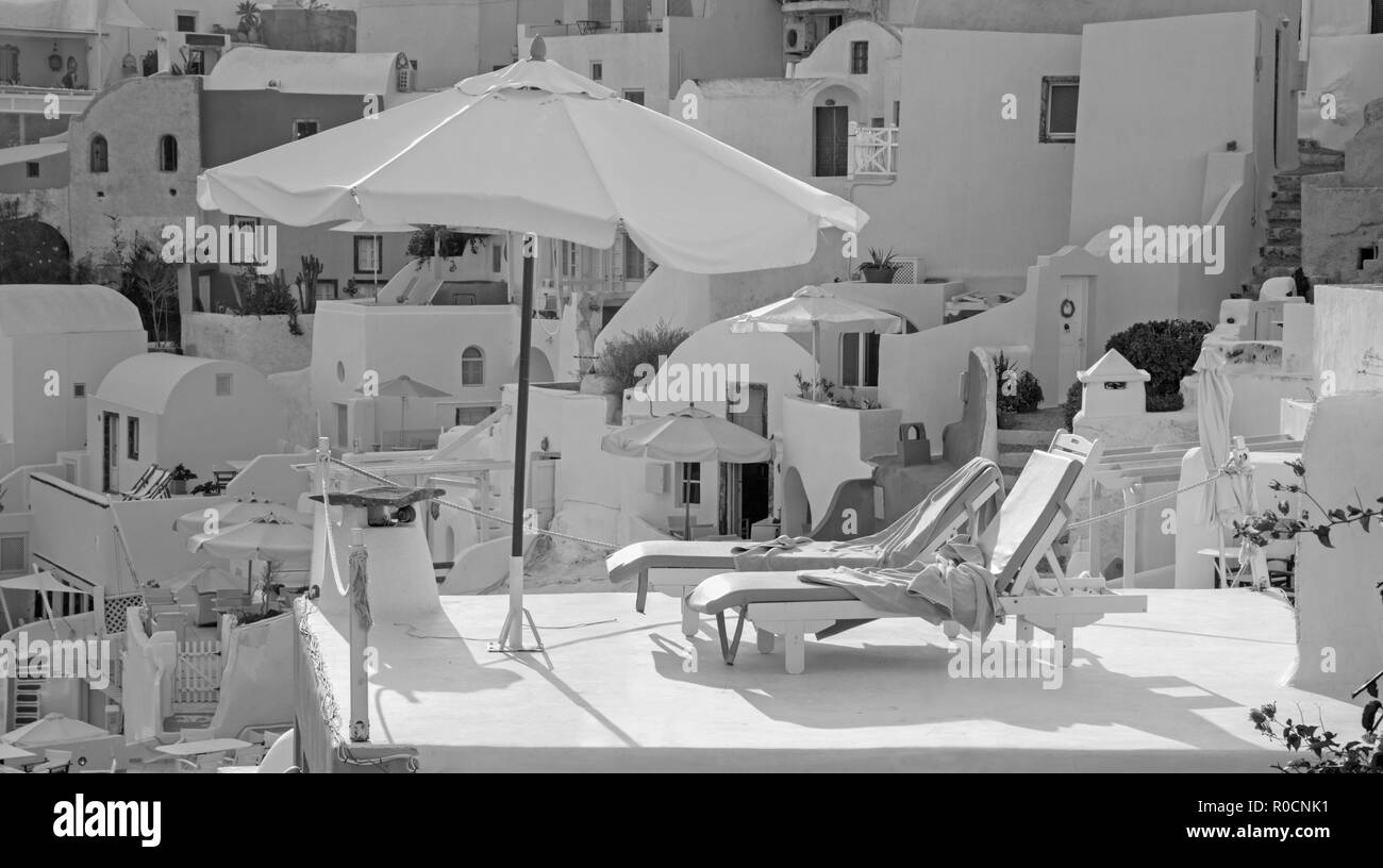 Santorini - The typically little houses and deck-chairs in Oia. Stock Photo
