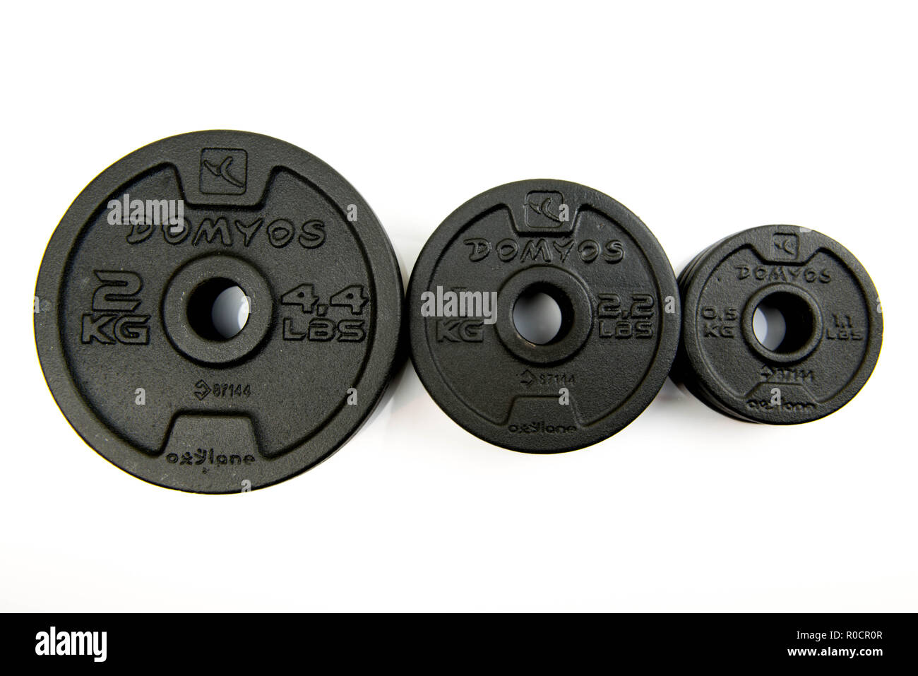 Black steel weights for dumbbells from the brand Domyos. half, one and two  kilogram weights Stock Photo - Alamy