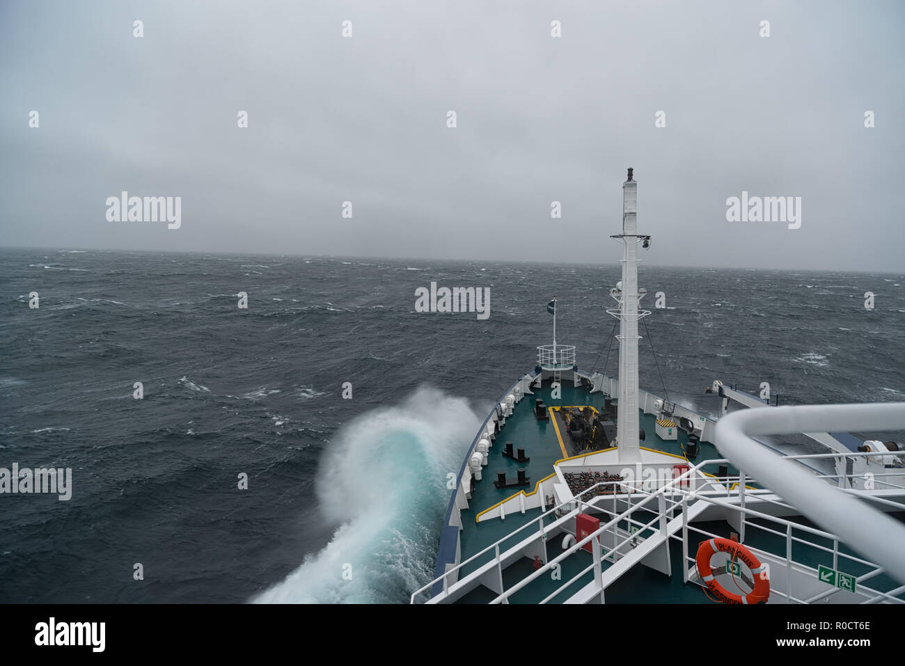 Ship cruising in storm and heavy seas crossing the Denmark Strait between Greenland and Iceland. Stock Photo