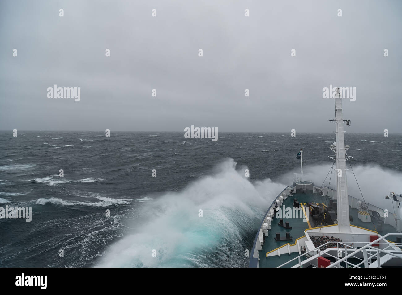 Ship cruising in storm and heavy seas crossing the Denmark Strait between Greenland and Iceland. Stock Photo