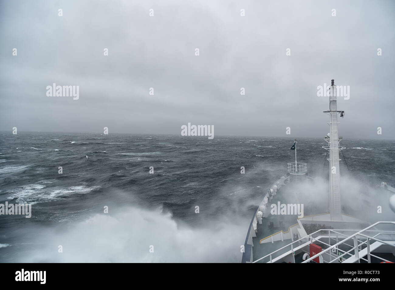 Ship cruising in storm and heavy seas crossing the Denmark Strait between Greenland and Iceland. Stock Photo